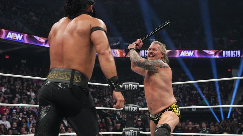 Chris Jericho about to strike Bandido with a baseball bat at AEW Dynasty