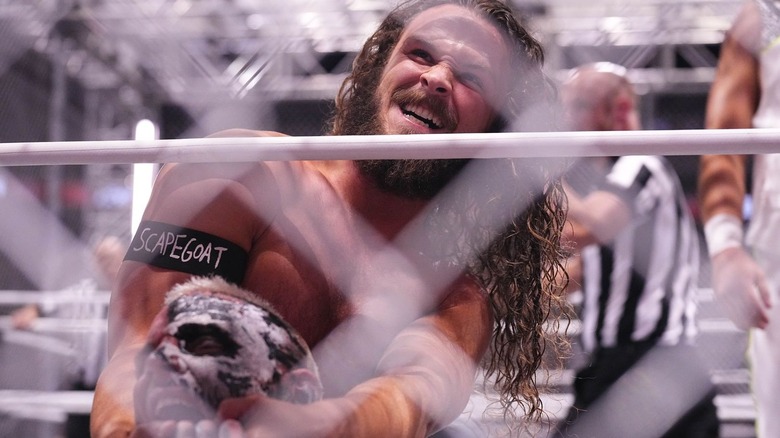Jack Perry chokes Darby Allin inside a cage