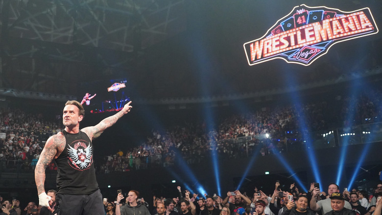 CM Punk points to the WrestleMania sign, a popular trademark during  WrestleMania season
