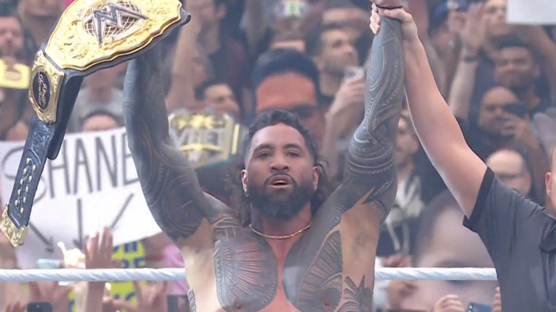 Jey Uso holds up the World Heavyweight Championship.