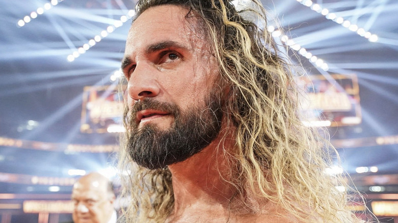 Seth Rollins looks over his shoulder in the final moments of WrestleMania 41. Paul Heyman smirks in the background.