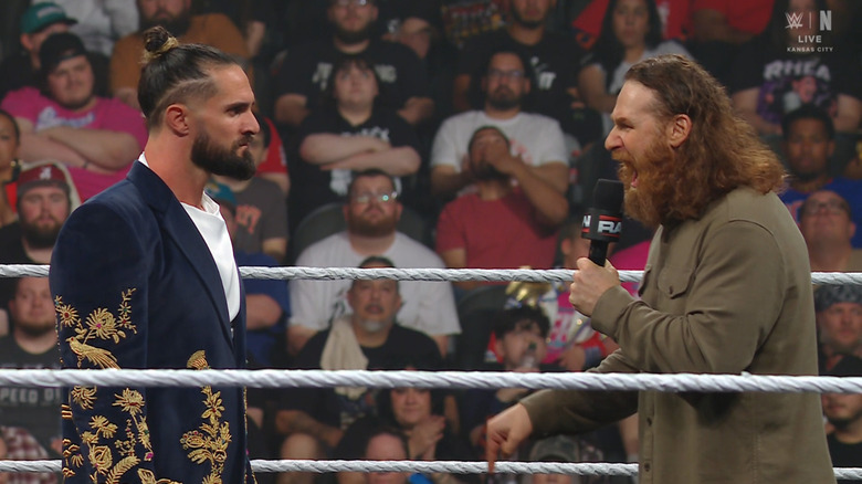 Rollins and Zayn talking in the ring